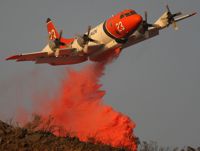 Airplane drops fire retardant